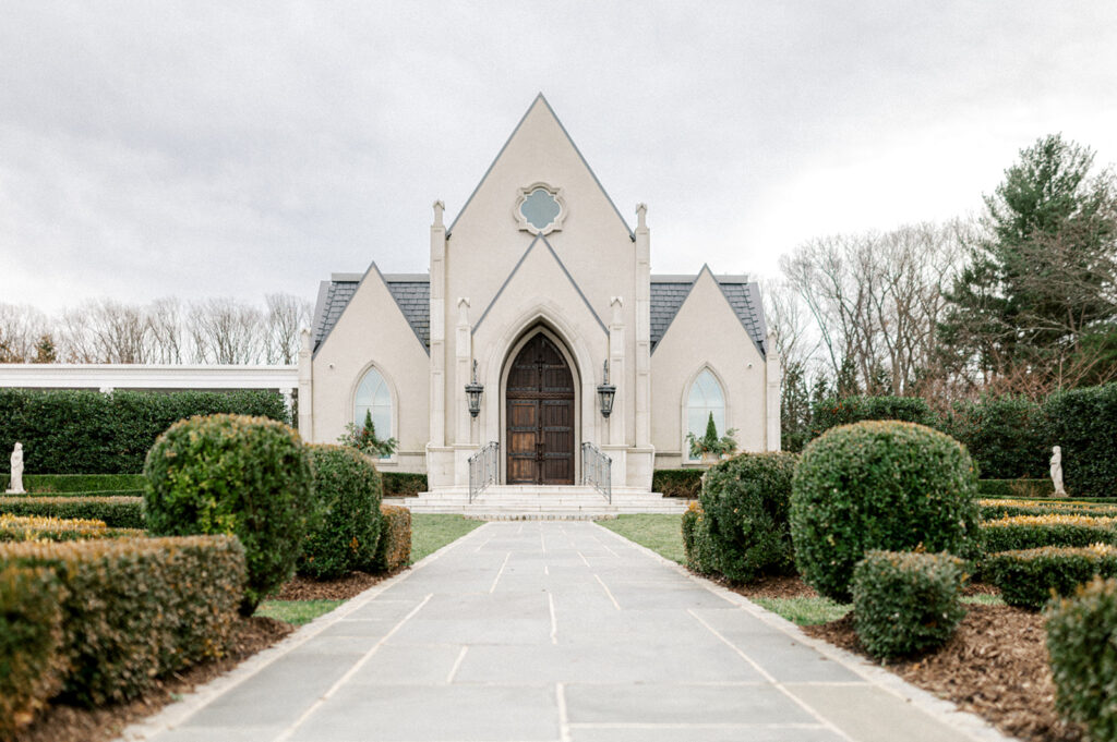 Exterior photo of the ceremony chapel and gardens at French style Park Chateau wedding venue in New Jersey | Photo by Lindsey Ford Photography