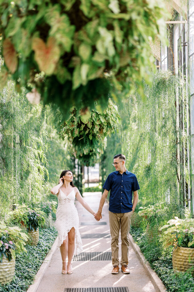 Couple holds hands and walks through Longwood Gardens | Longwood Gardens Engagement Photo Session in Philadelphia by Lindsey Ford Photography