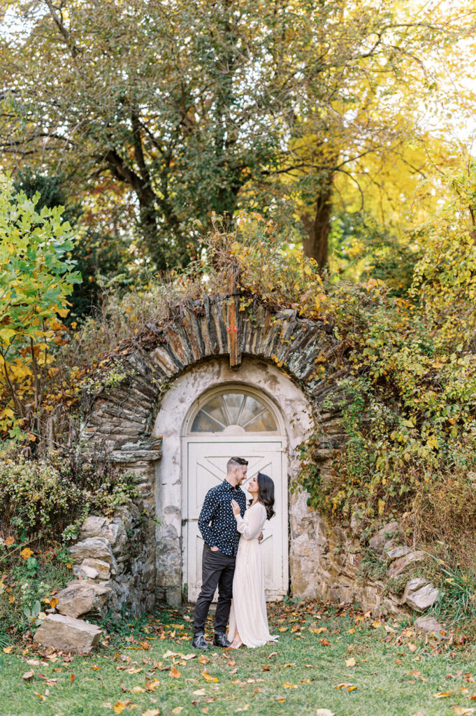 Couple poses in front of abandoned doorway | Valley Forge Engagement Session by Lindsey Ford Photography