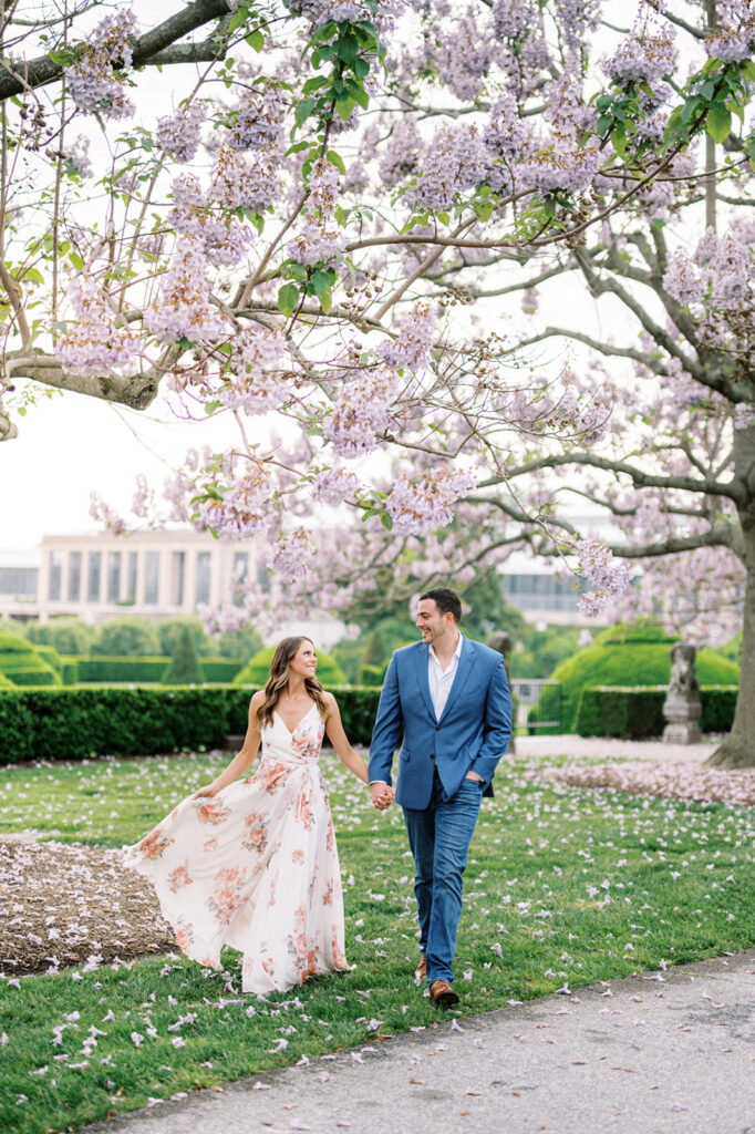 Couple poses under Cherry Blossom trees at Longwood Gardens | Longwood Gardens Engagement Photo Session in Philadelphia by Lindsey Ford Photography
