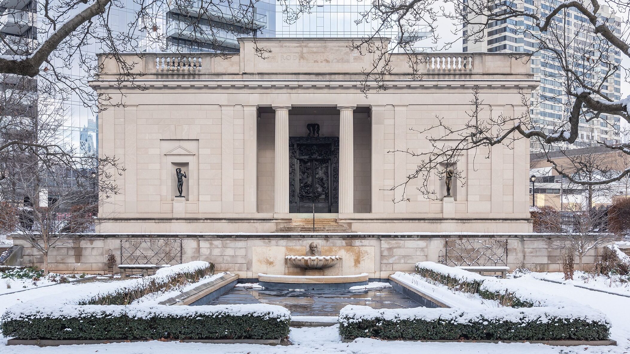 The Rodin Museum in Philadelphia surrounded by snow in winter | Wintertime outdoor engagement session locations in Philadelphia