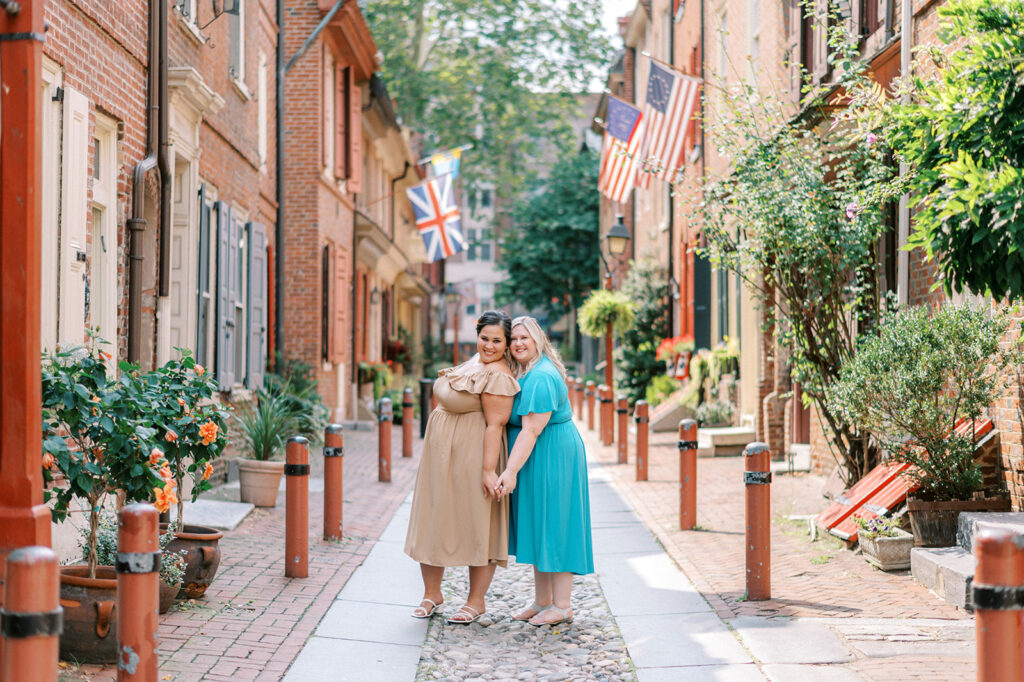 Two women pose in Elfreth's Alley for their engagement session in Old City Philadelphia