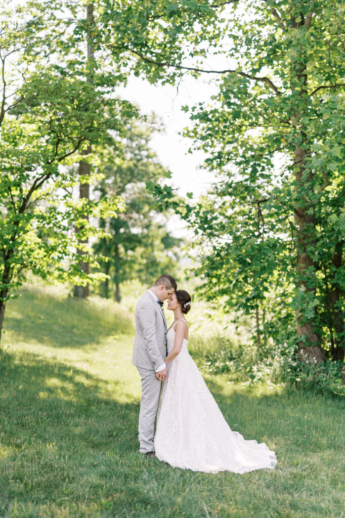 Bride and groom pose for couple portraits in a grove of trees during their intimate micro wedding at Hauser Hill  | 2024 Wedding trends by Lindsey Ford Photography