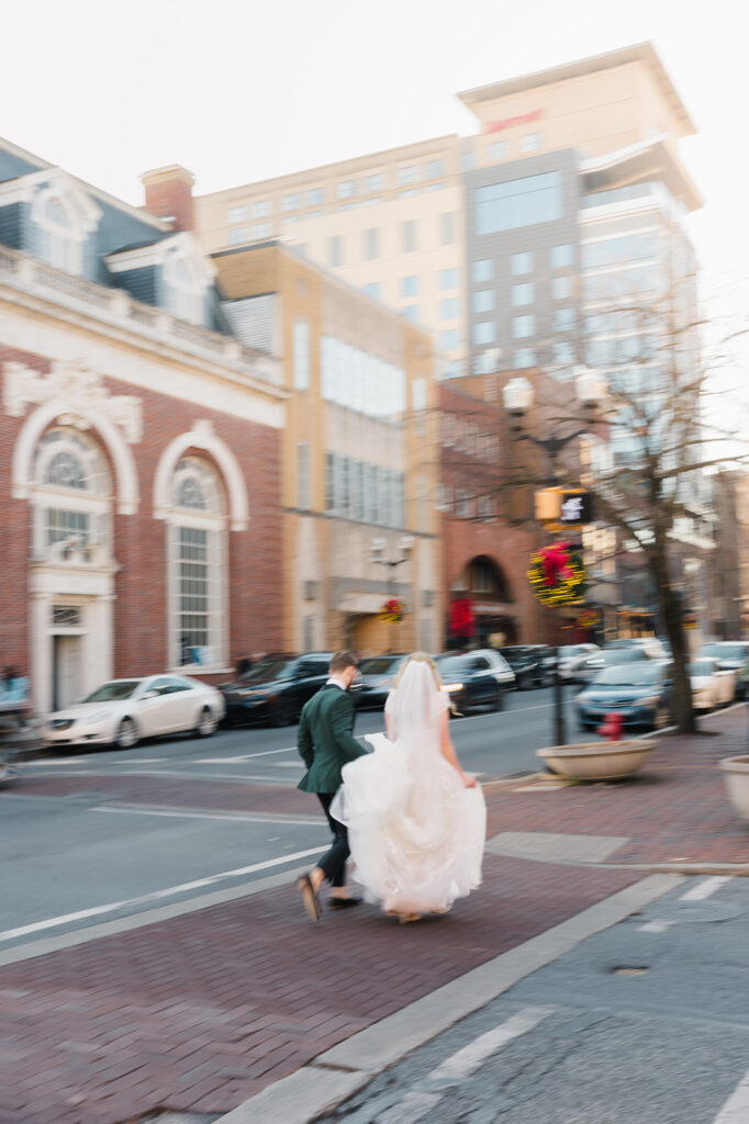 Bride and groom run through the streets of downtown Lancaster