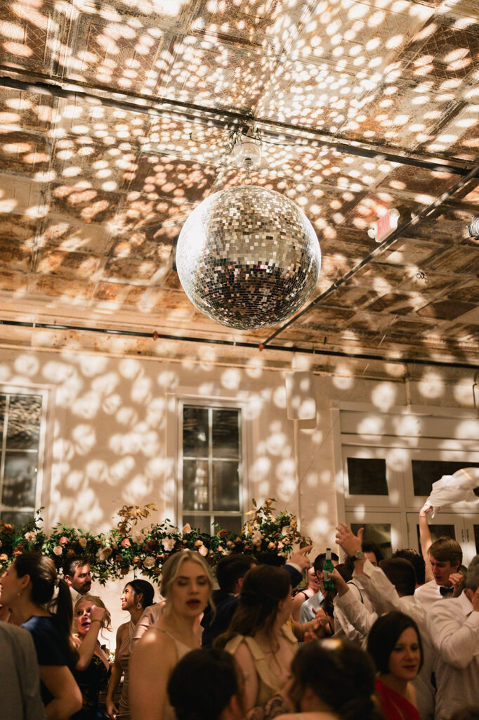 Large disco ball hangs over dance floor at Excelsior venue