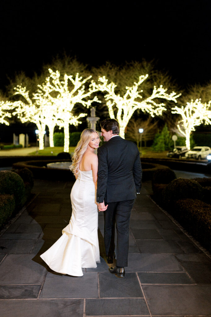 nighttime portait of a couple walking together at the Park Chateau wedding venue in February