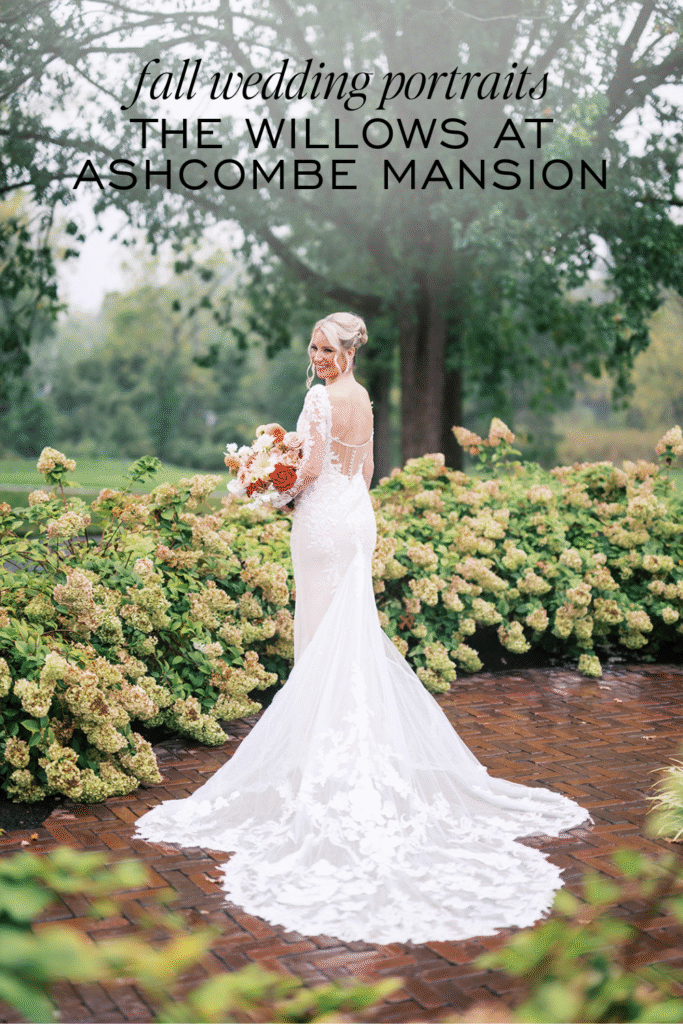 Bride in lace wedding dress with cathedral train poses in hydrangea garden at The Willows at Ashcombe fall wedding