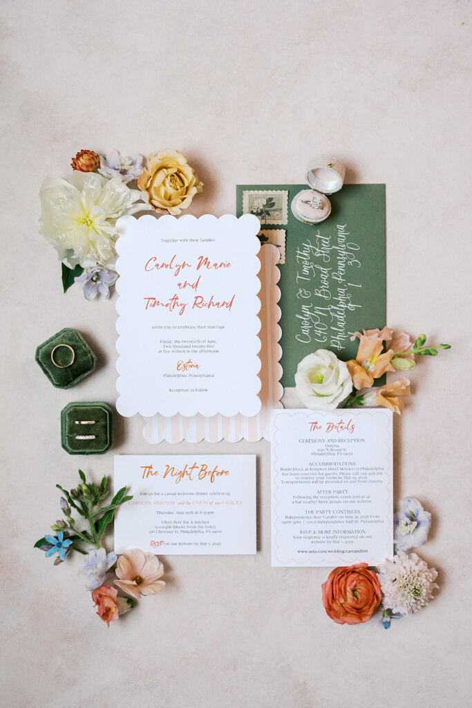 Fun green and orange wedding invitation suite is arranged artfully on a tan styling mat for a flat lay detail photo | Lindsey Ford Photography