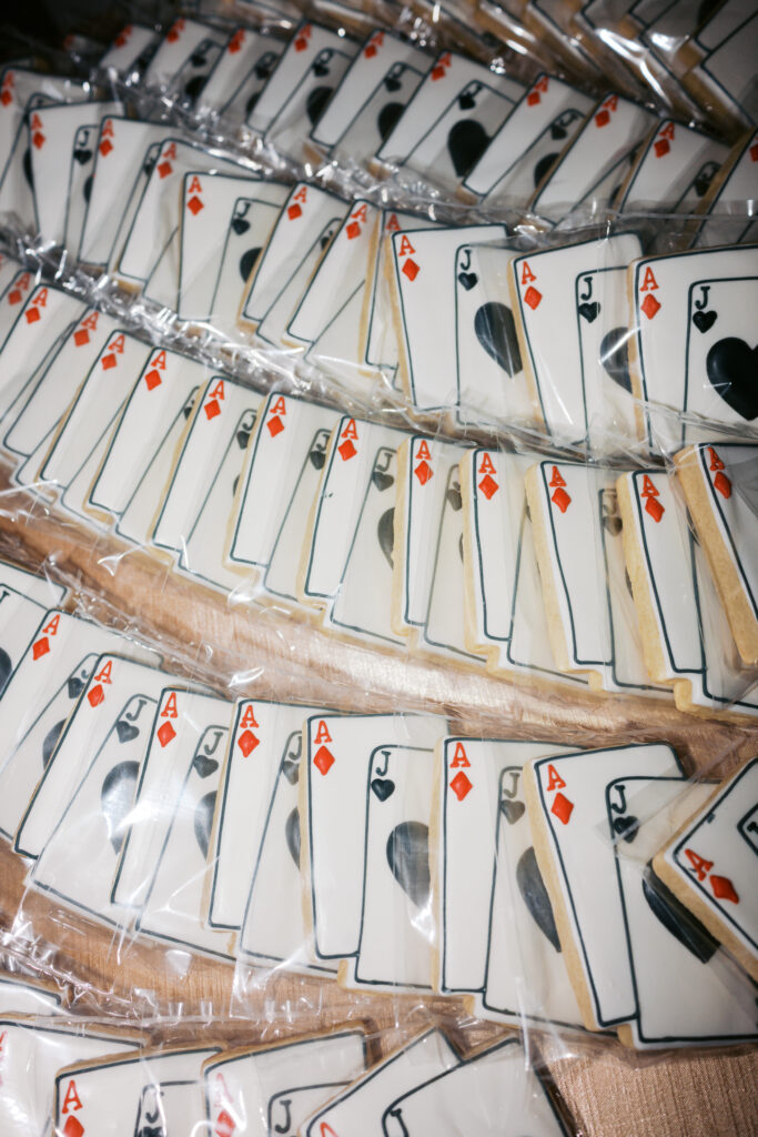 Royal icing cookies wedding favor decorated with a black, white, and red playing card design