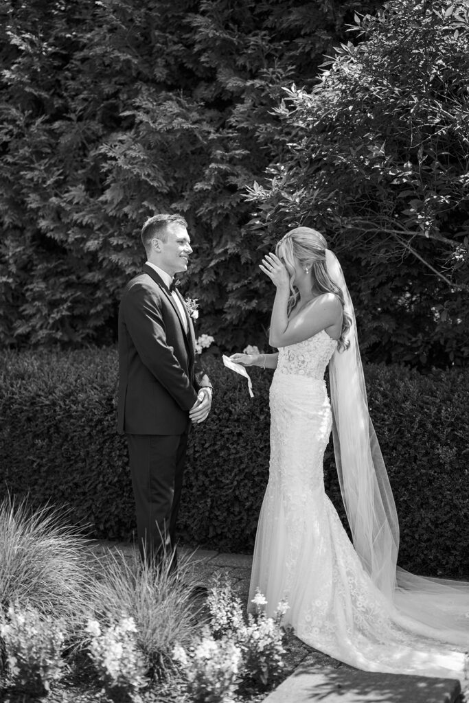 Emotional first look moment black and white Lake House Inn garden Pennsylvania wedding