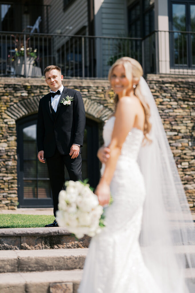 Emotional first look groom reaction with Lake House Inn architectural backdrop Pennsylvania wedding photography