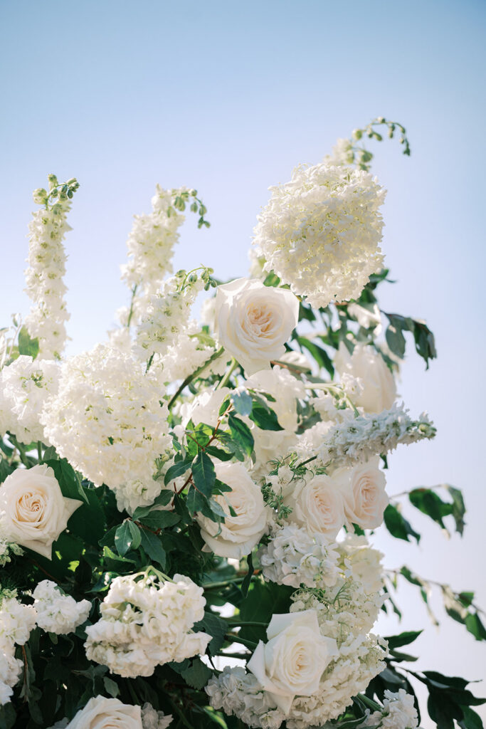 Elegant white rose and hydrangea wedding florals by Bloom Flower Co at Lake House Inn