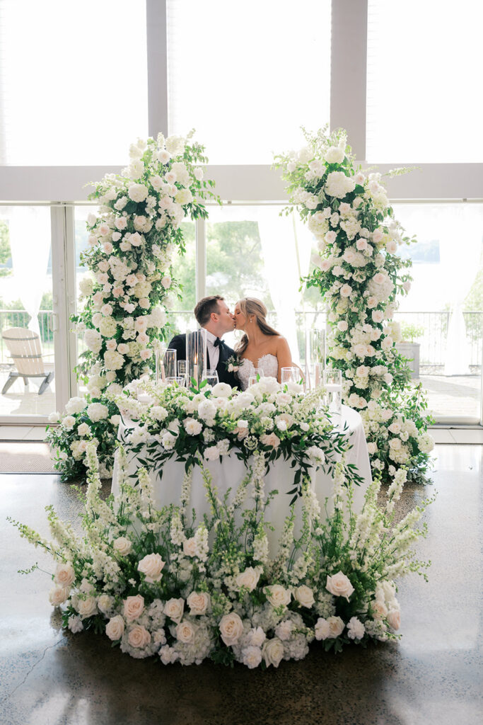 Breathtaking sweetheart table with cascading white floral installation floor to ceiling Lake House Inn wedding Pennsylvania