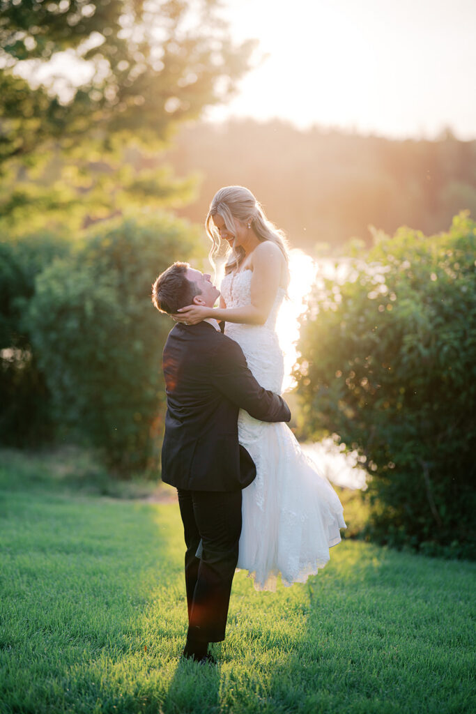 Golden hour groom lift nontraditional wedding photography unique pose ideas Lake House Inn lakefront Pennsylvania