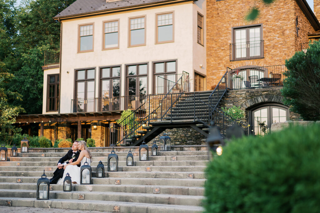 Stunning Lake House Inn grand staircase couple portrait with lanterns at sunset Perkasie Pennsylvania wedding