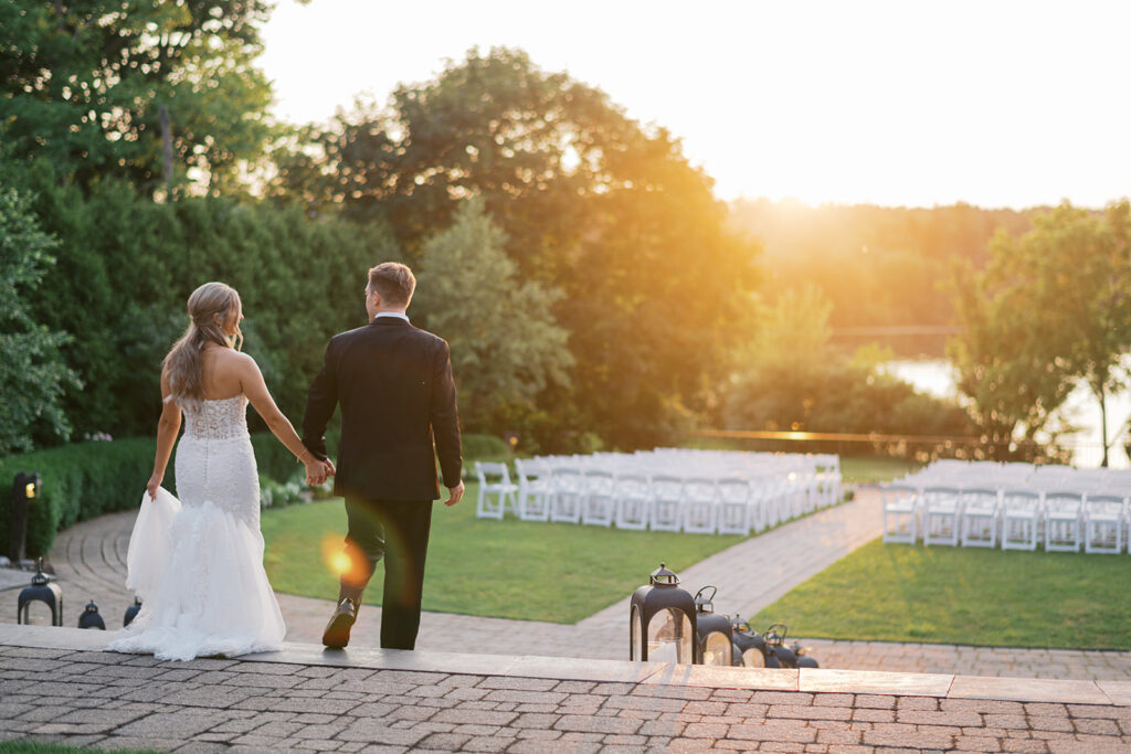 Golden hour couple walking toward lakefront ceremony site nontraditional wedding pictures Lake House Inn Pennsylvania