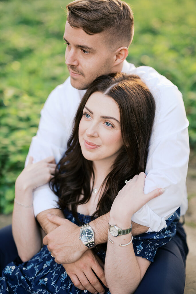 Couple embracing in warm evening light during engagement session pictures