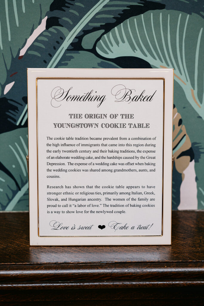 Sign with a header that reads "Something Baked The Origin of The Youngstown Cookie Table" with an explanation beneath