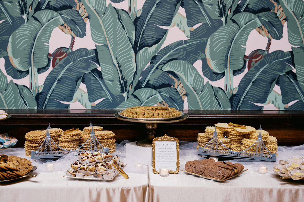 Traditional Youngstown cookie table with various trays of cookies and pastries is laid out for an Elkins Estate wedding